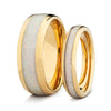 Two gold his and hers wedding bands with white opal on a white background