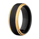 Black ring with gold band on a white background