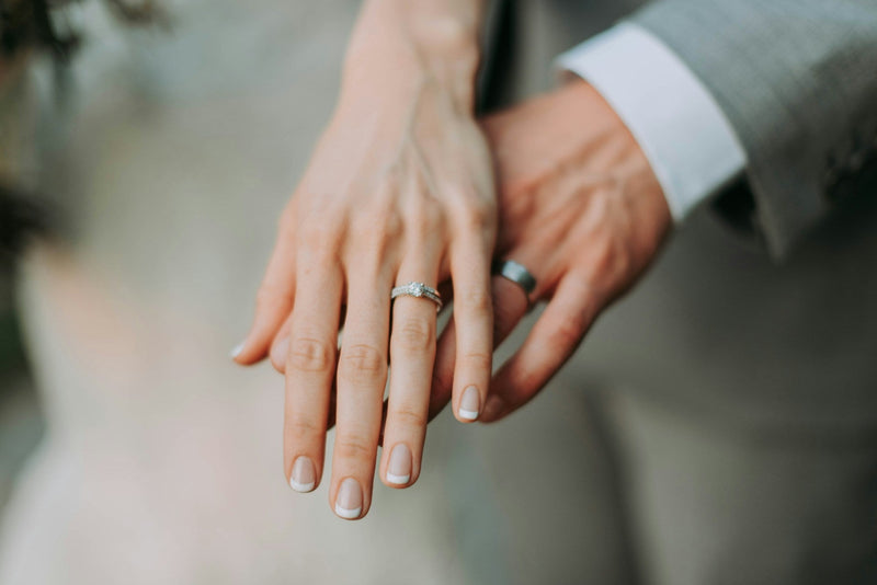 A couple’s hands with wedding bands