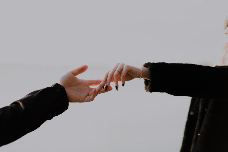 two hands reaching out together