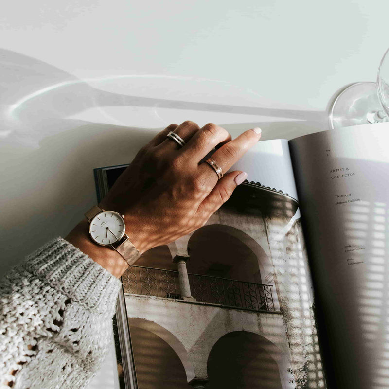 A woman wearing wedding bands and a watch