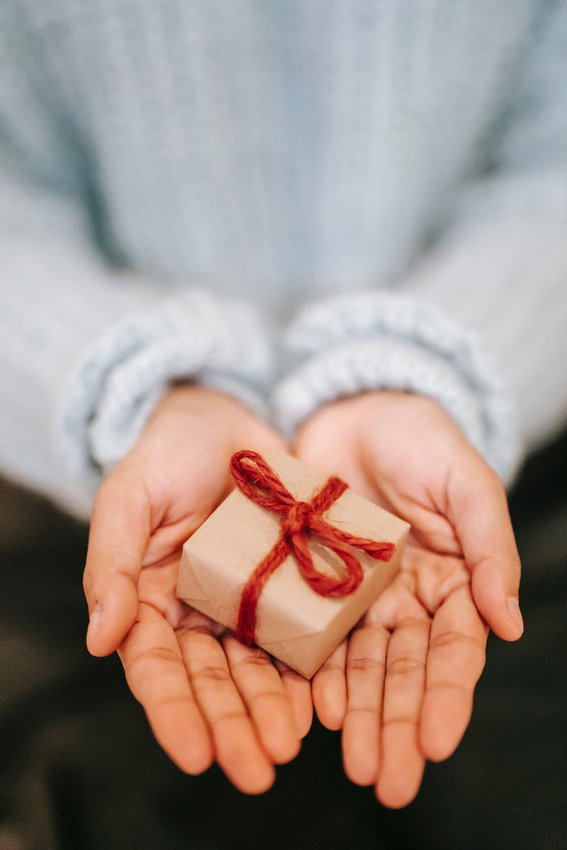 A woman holding a small gift box