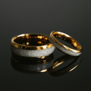 Two gold tungsten rings with opal inlay on a black background