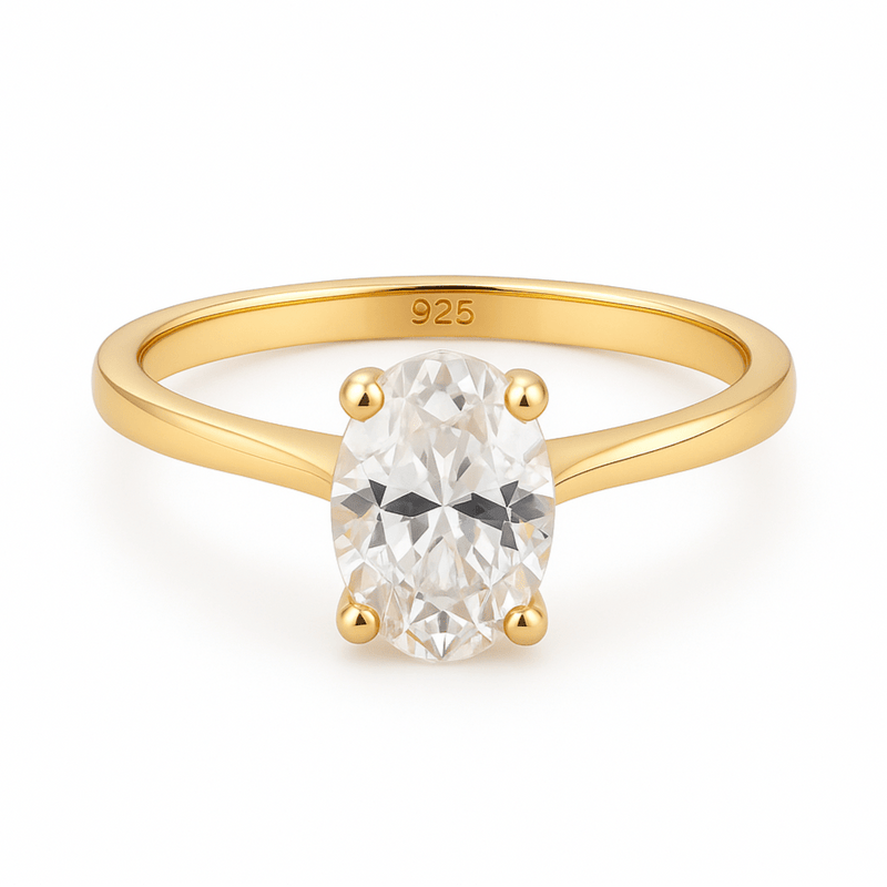 Gold plated engagement ring with an oval diamond on a white background