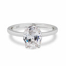 Silver solitaire ring with a large oval diamond on a white background
