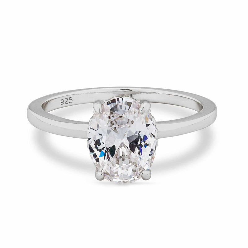 Silver solitaire ring with a large oval diamond on a white background