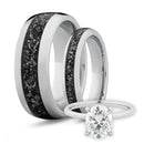 Two his and hers white gold meteorite wedding bands with an oval diamond engagement ring on white background