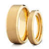 Two gold his and hers wedding bands on a white background