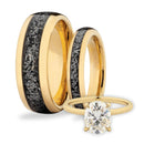 Gold ring with meteorite inlay and diamond engagement ring on a white background
