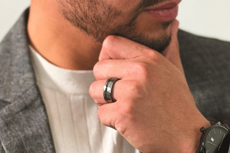 Man wearing The Legacy men's black minimalist watch and The Anakin tungsten hammered ring
