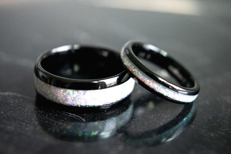 The Beast & Beauty 2.0 matching opal wedding bands sitting on their sides