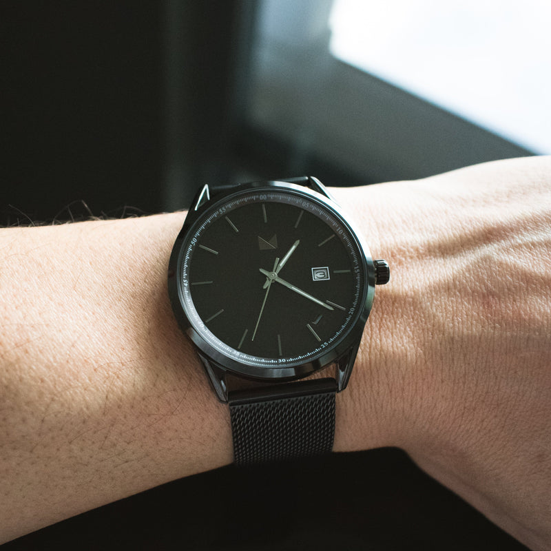 The Legacy men's black minimalist watch on a wrist