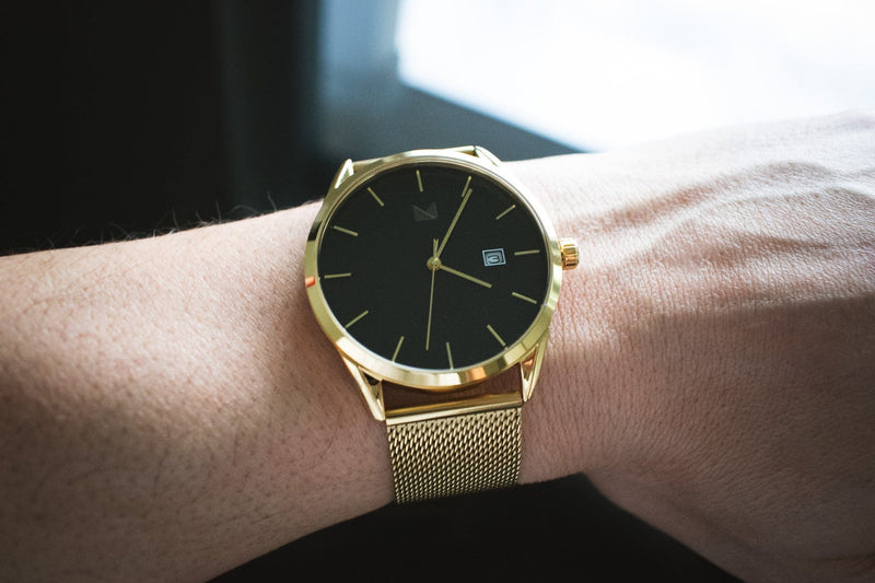 The Prestige men's gold mesh watch on a wrist