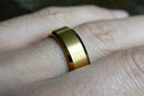 The Executive men's gold tungsten ring on a hand