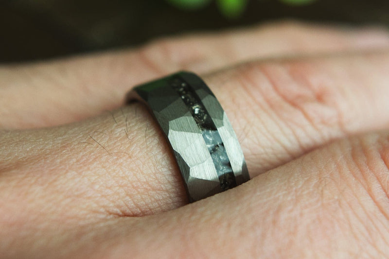 meteorite wedding ring on a hand