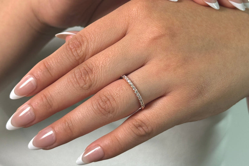 A woman wearing a rose gold half eternity band 