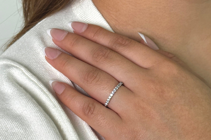 a woman wearing the 925 sterling silver wedding band on her hand