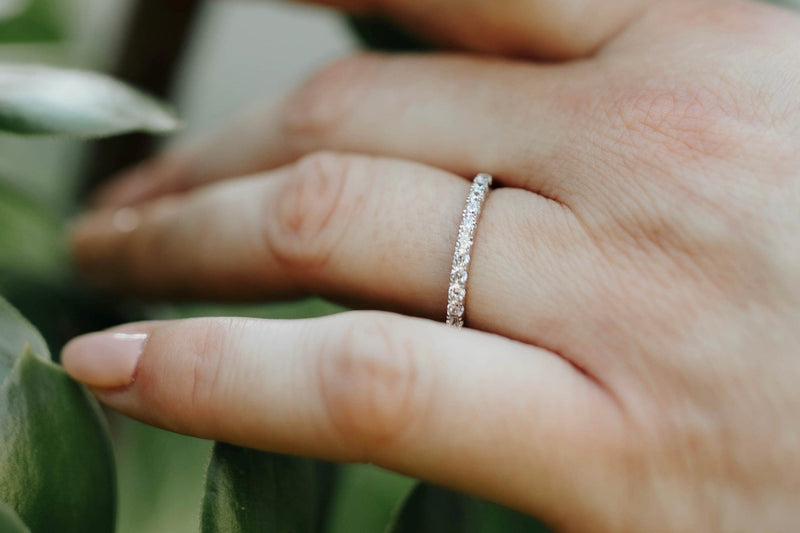 Woman’s hand wearing a sterling silver eternity band
